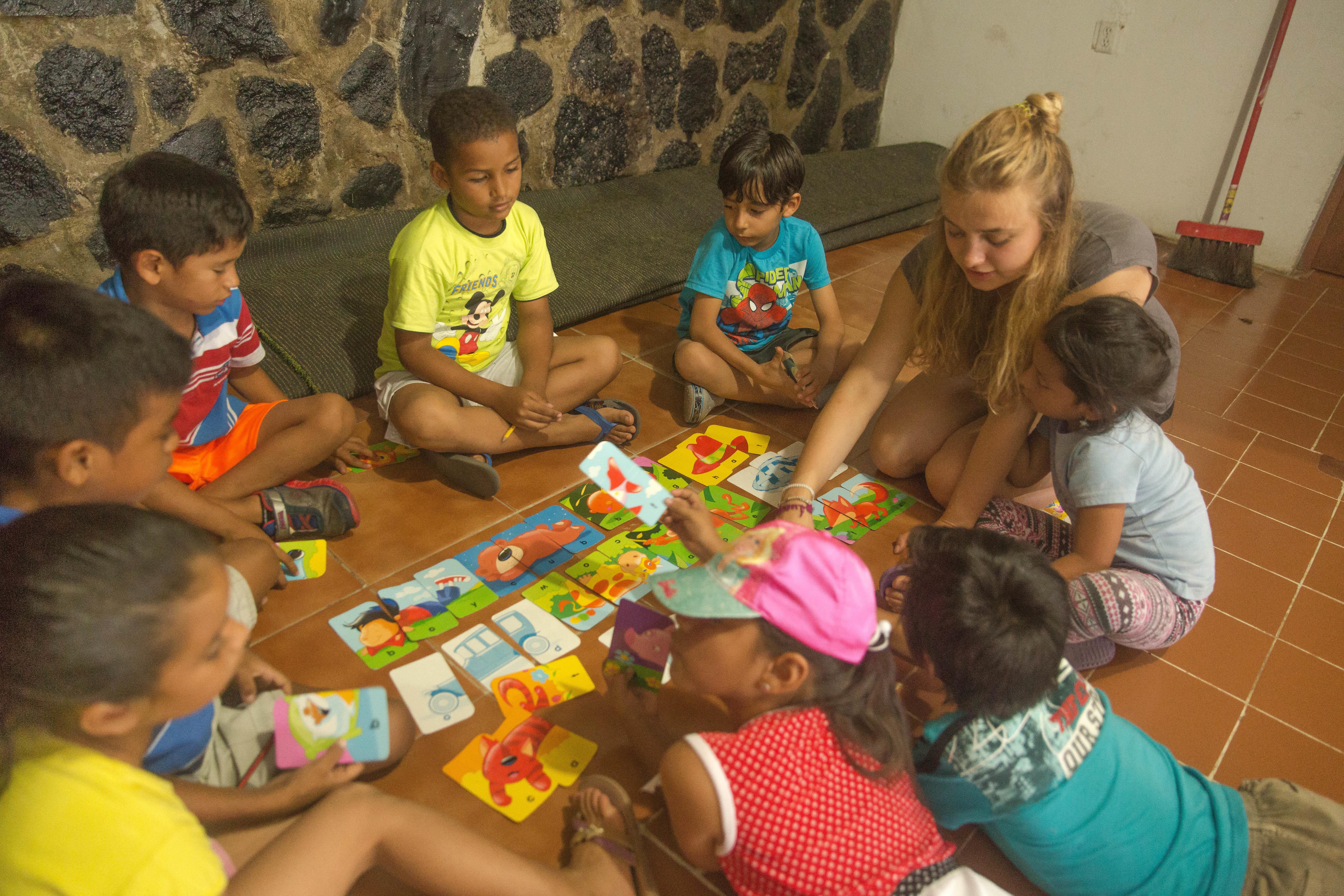 Projects Abroad volunteer uses flash cards with her students during her teaching work experience in Ecuador Flashcards are used to teach the children English words at one of our volunteer teaching placements in Ecuador